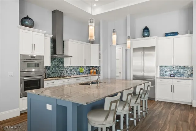 a kitchen with granite countertop a table chairs stove and cabinets