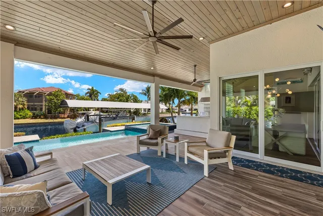 a outdoor space with patio the couches and pool table with chairs