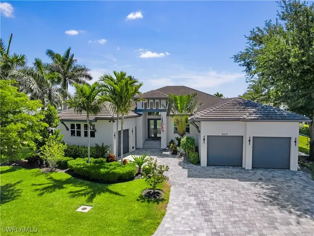 a front view of a house with garden and plants