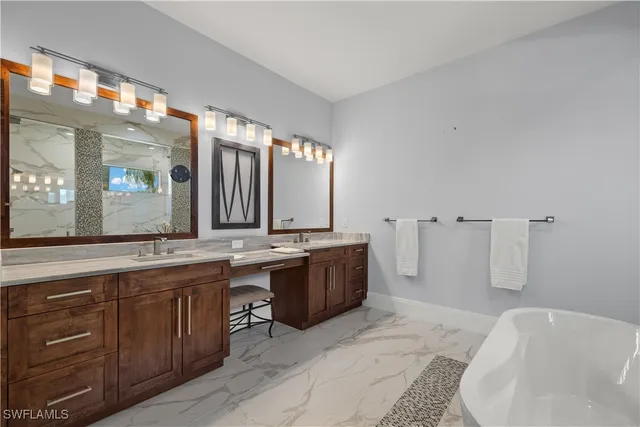 a bathroom with a tub sink and mirror