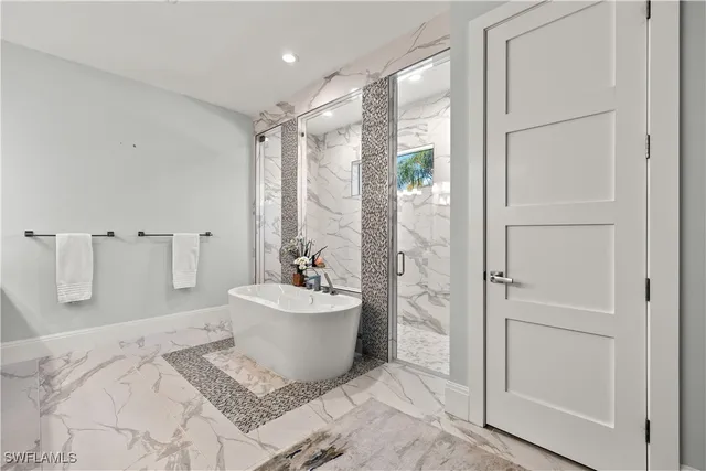 a spacious bathroom with a bathtub and sink