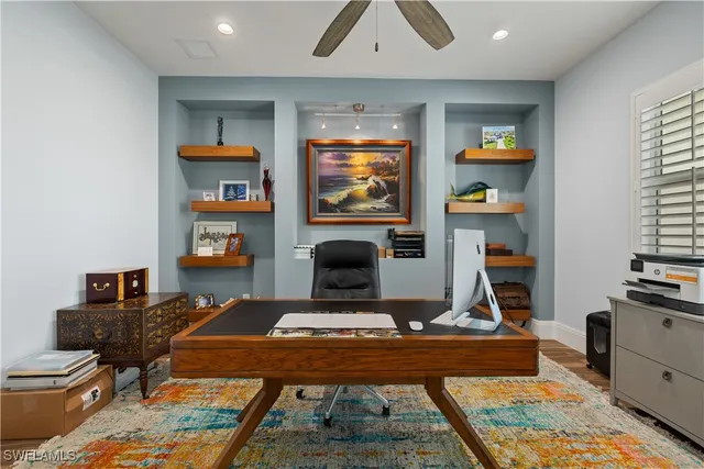 a living room with furniture a flat screen tv and a rug