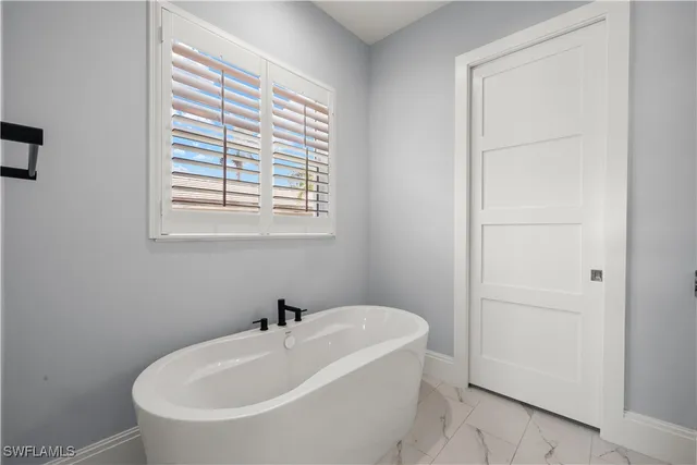 a white bath tub sitting next to a white sink