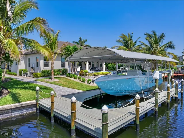 a view of a swimming pool with lounge chairs in patio