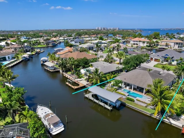 an aerial view of residential houses with outdoor space and river