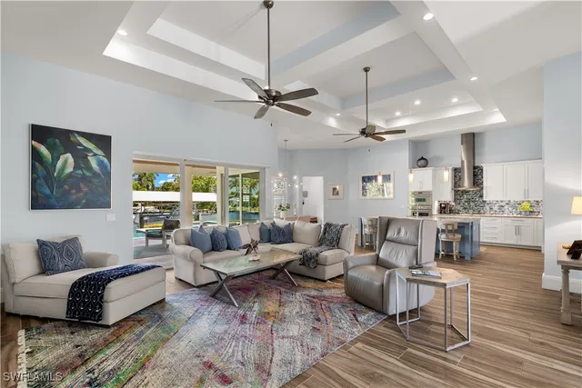 a living room with furniture ceiling fan and a rug