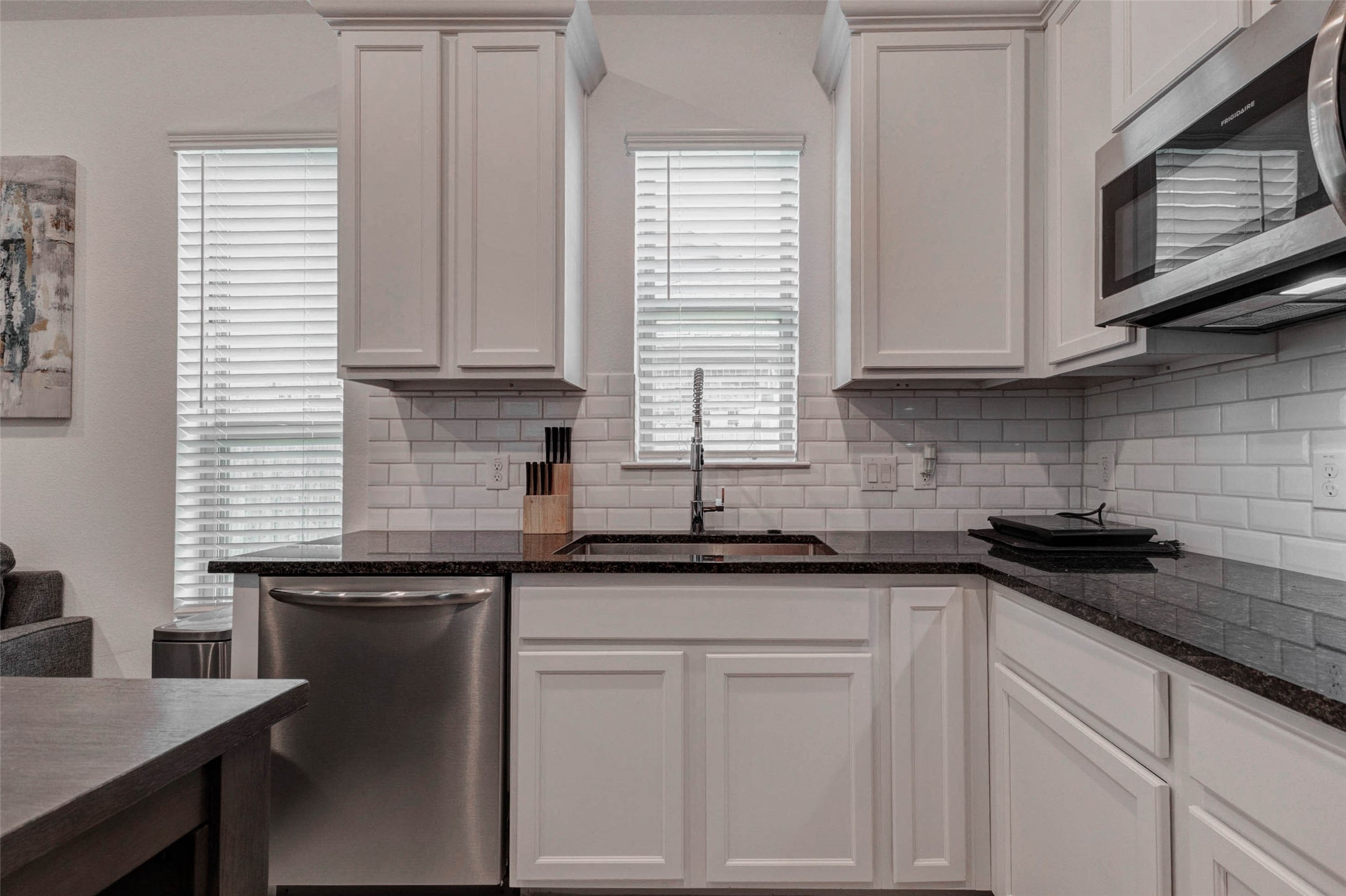 3711 Castle Rock Drive Rosenberg, TX 77469 - Photo 9 of 46 a kitchen with granite countertop white cabinets sink and window