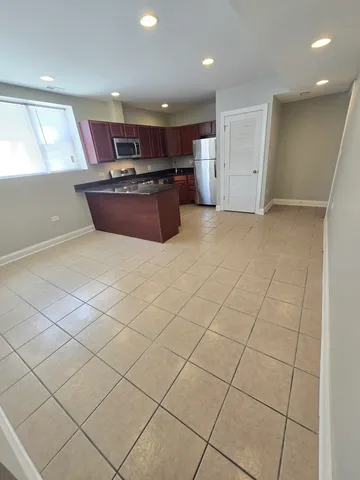 a kitchen with stainless steel appliances granite countertop a sink and a stove top oven
