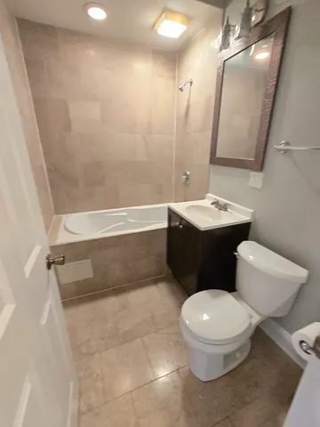 a white toilet sitting next to a bathroom sink
