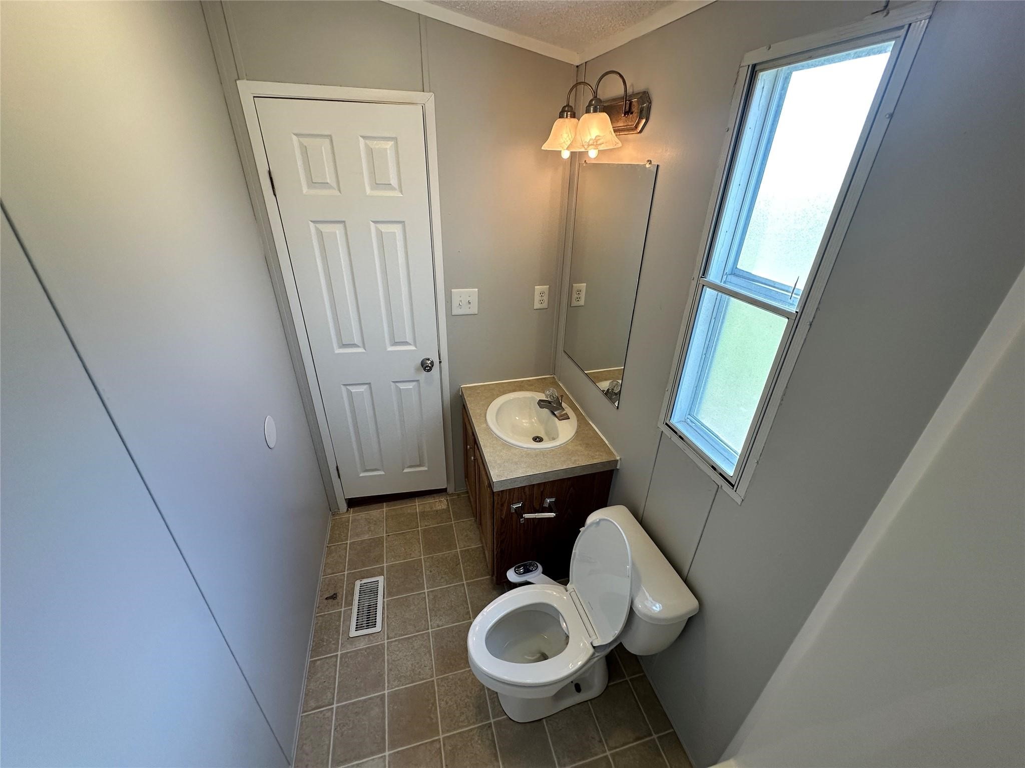 30841 Clyde Lane Hockley, TX 77447 - Photo 20 of 26 a bathroom with a toilet and a sink