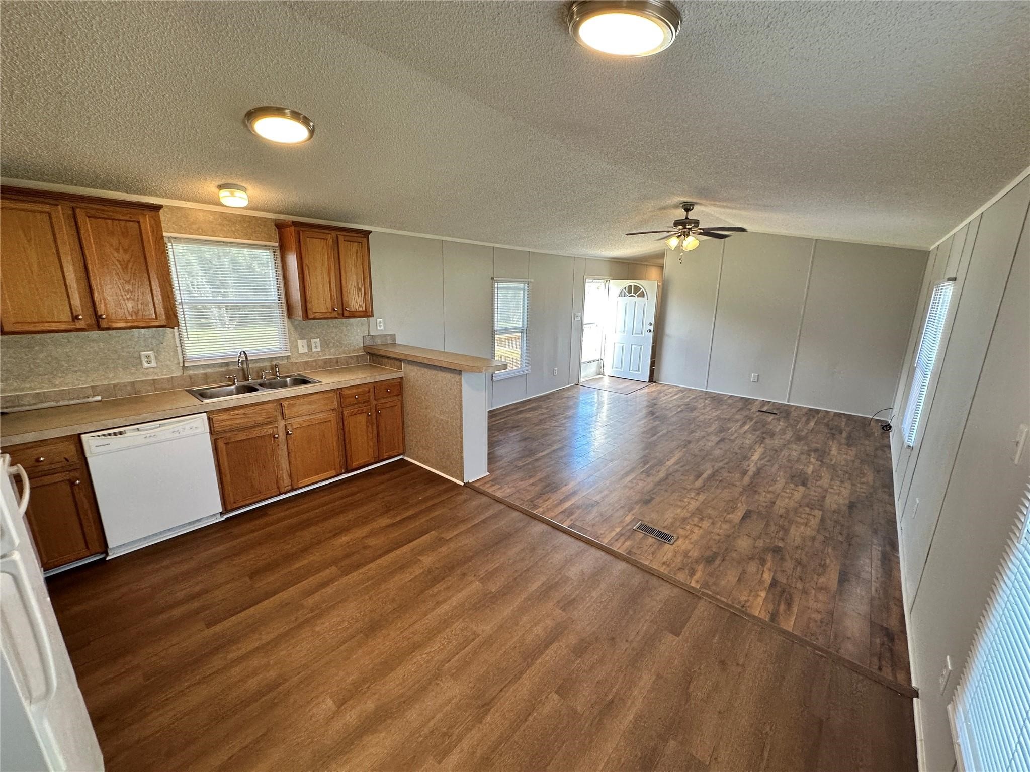 30841 Clyde Lane Hockley, TX 77447 - Photo 6 of 26 a kitchen with stainless steel appliances granite countertop a sink dishwasher and a stove with wooden floor