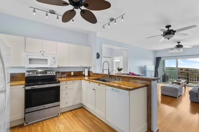 a kitchen with stainless steel appliances granite countertop a sink and stove top oven