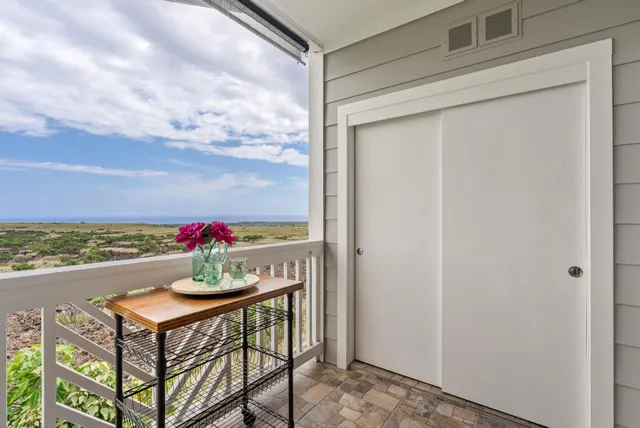 a view of an outdoor dining space with a table and chairs