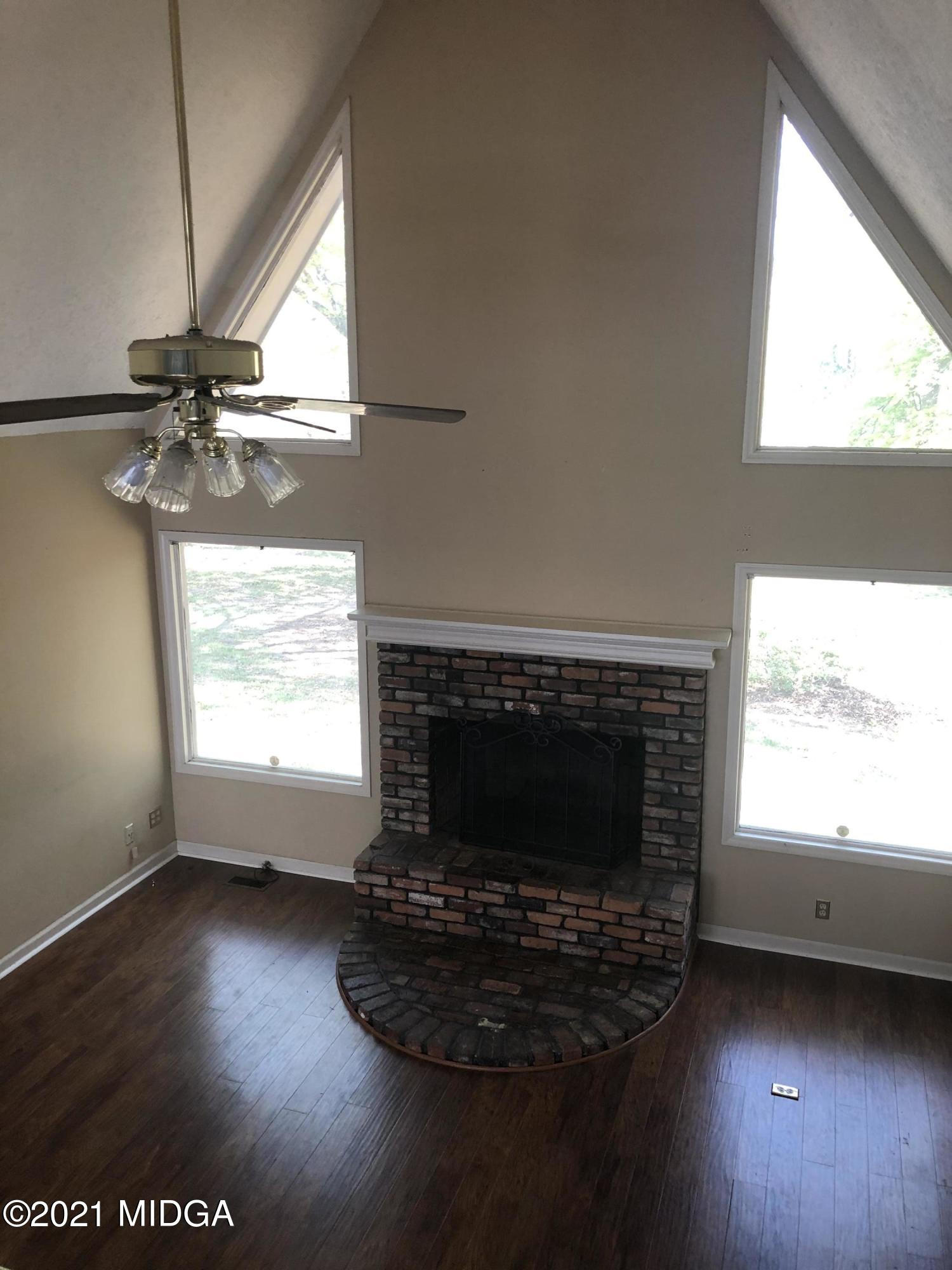 4980 Dixon Road Lizella, GA 31052 - Photo 3 of 10 a living room with a fireplace and a window