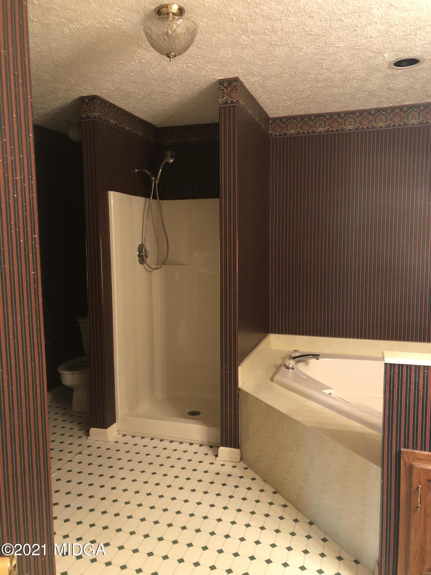 4980 Dixon Road Lizella, GA 31052 - Photo 7 of 10 a bathroom with a sink and a shower