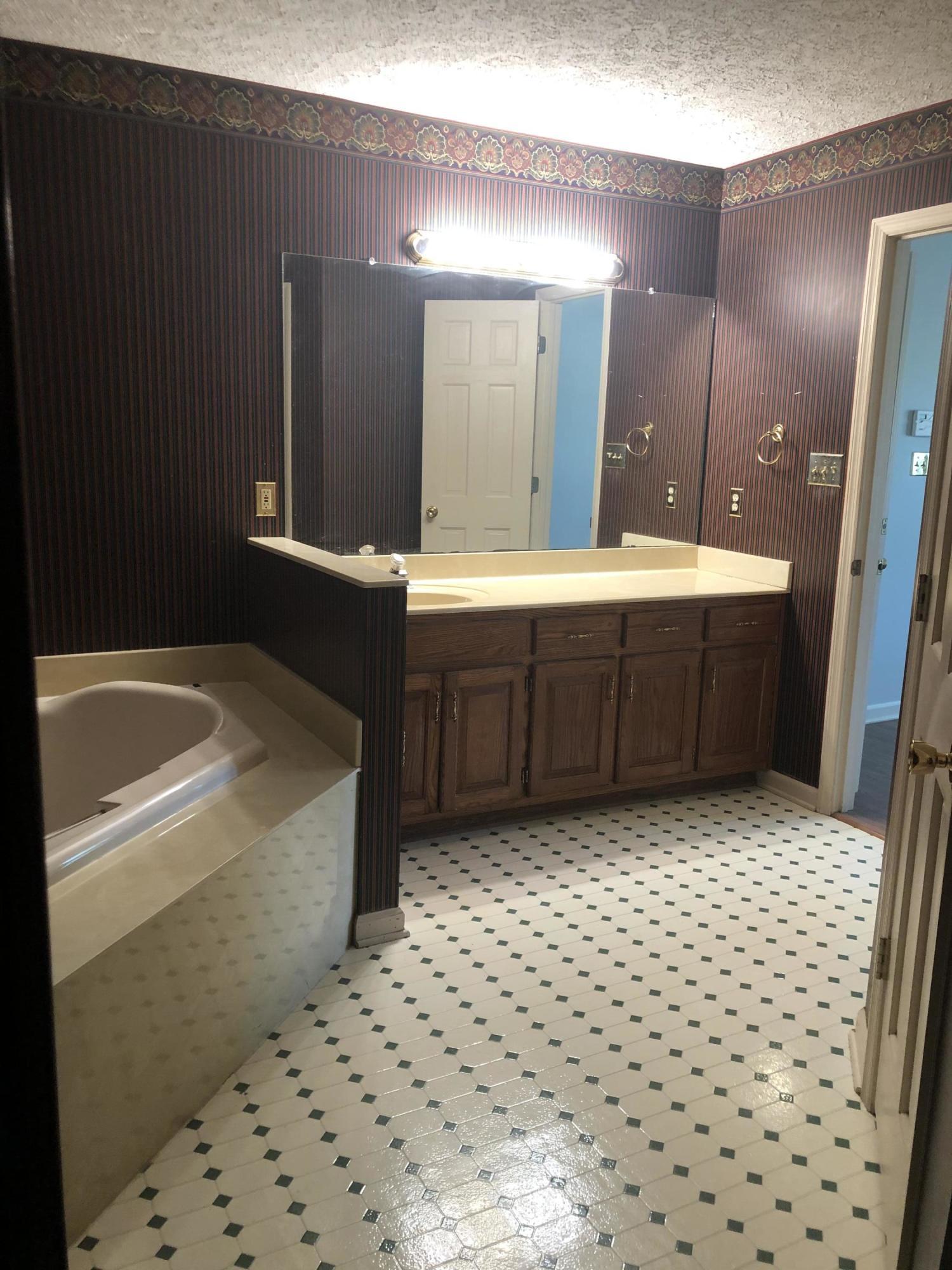 4980 Dixon Road Lizella, GA 31052 - Photo 8 of 10 a bathroom with a bathtub and a shower