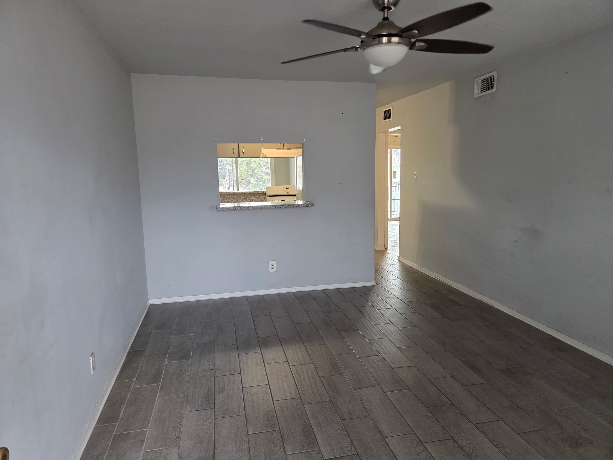 306 North Street, Unit 14 Houston, TX 77009 - Photo 2 of 17 an empty room with wooden floor fan and windows
