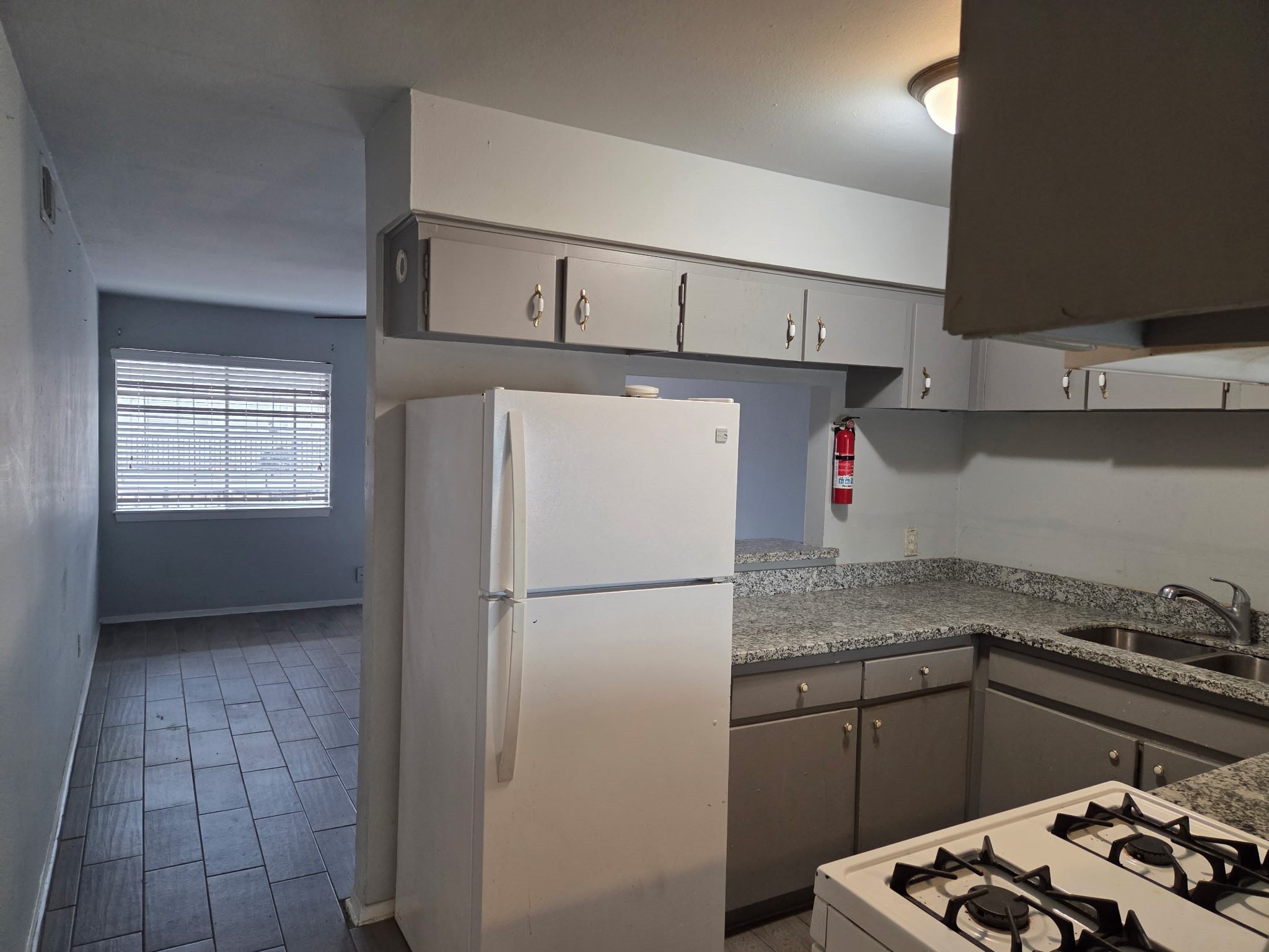306 North Street, Unit 14 Houston, TX 77009 - Photo 4 of 17 a kitchen with a refrigerator and a stove top oven