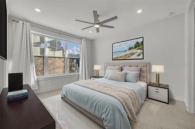 a bedroom with a large bed and a window