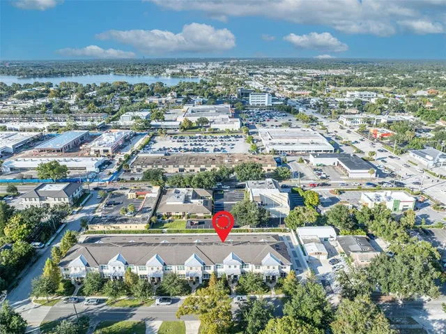 an aerial view of residential houses with outdoor space and lake view