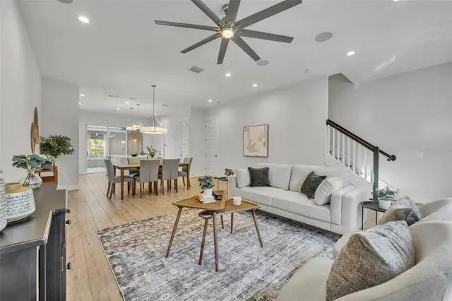 a living room with furniture and kitchen view