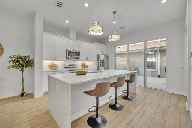 a large kitchen with a table and chairs