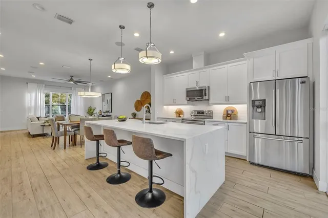 a kitchen with counter space appliances and wooden floor