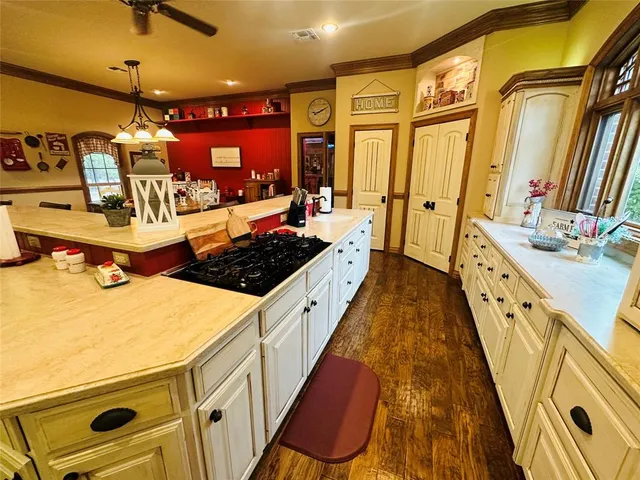a kitchen with stove and cabinets