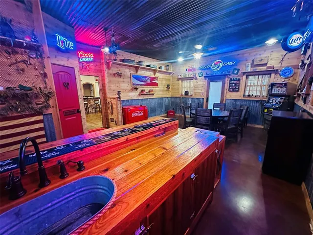 a bathroom with a sink a toilet and shower curtain