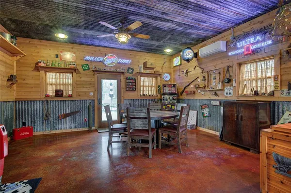 a living room with a wooden floor and a table