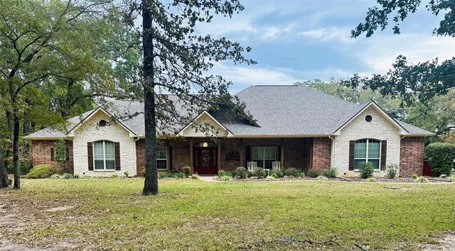 a front view of a house with a yard and porch