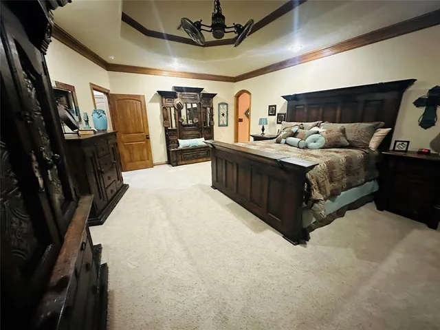 a bedroom with a large bed and a dresser