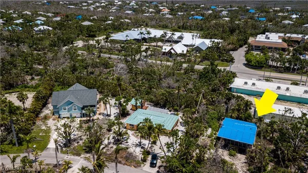 an aerial view of a house with a swimming pool yard and outdoor seating