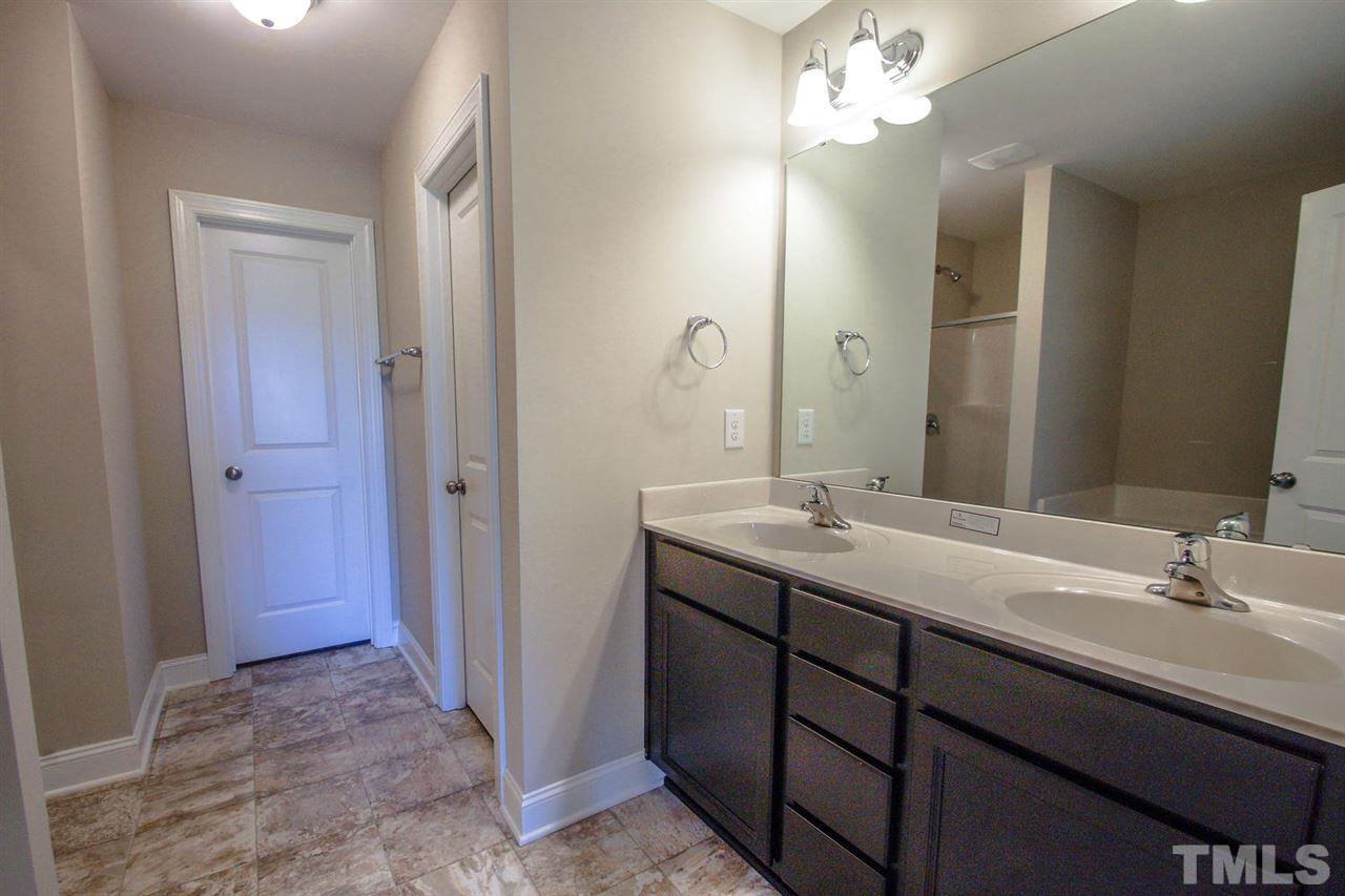 1124 Silver Farm Road Raleigh, NC 27603 - Photo 11 of 25 a bathroom with a double vanity sink and a mirror