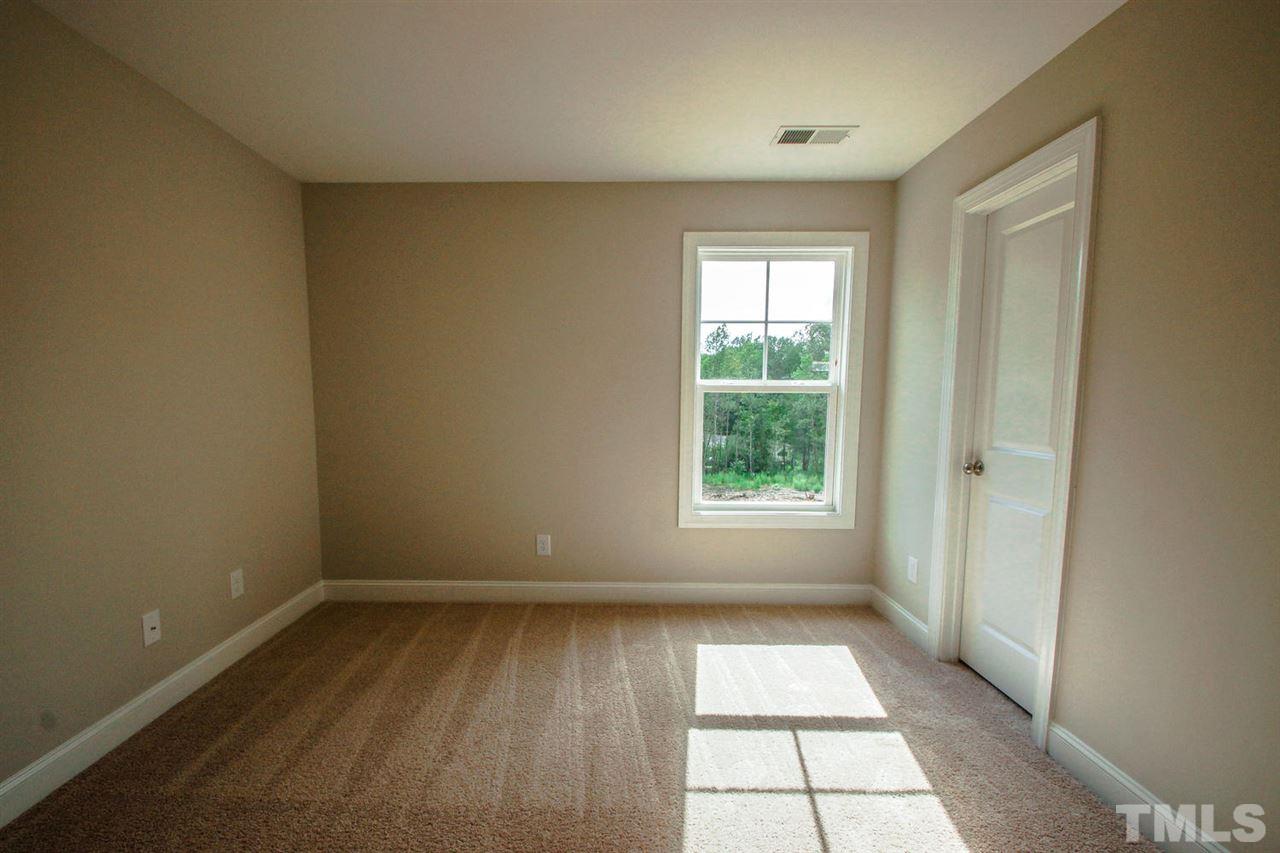 1124 Silver Farm Road Raleigh, NC 27603 - Photo 13 of 25 a view of empty room with wooden floor and fan