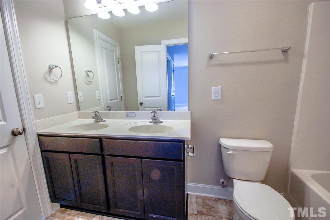 1124 Silver Farm Road Raleigh, NC 27603 - Photo 15 of 25 a bathroom with a toilet sink and mirror
