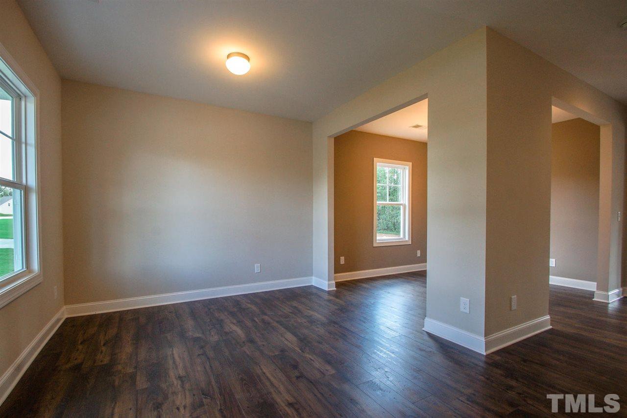 1124 Silver Farm Road Raleigh, NC 27603 - Photo 6 of 25 a view of an empty room with wooden floor and a window