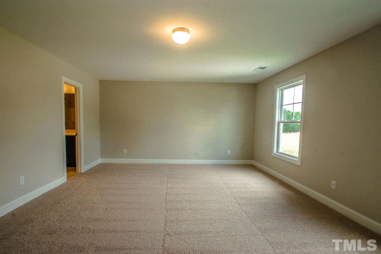 1124 Silver Farm Road Raleigh, NC 27603 - Photo 10 of 25 an empty room with windows