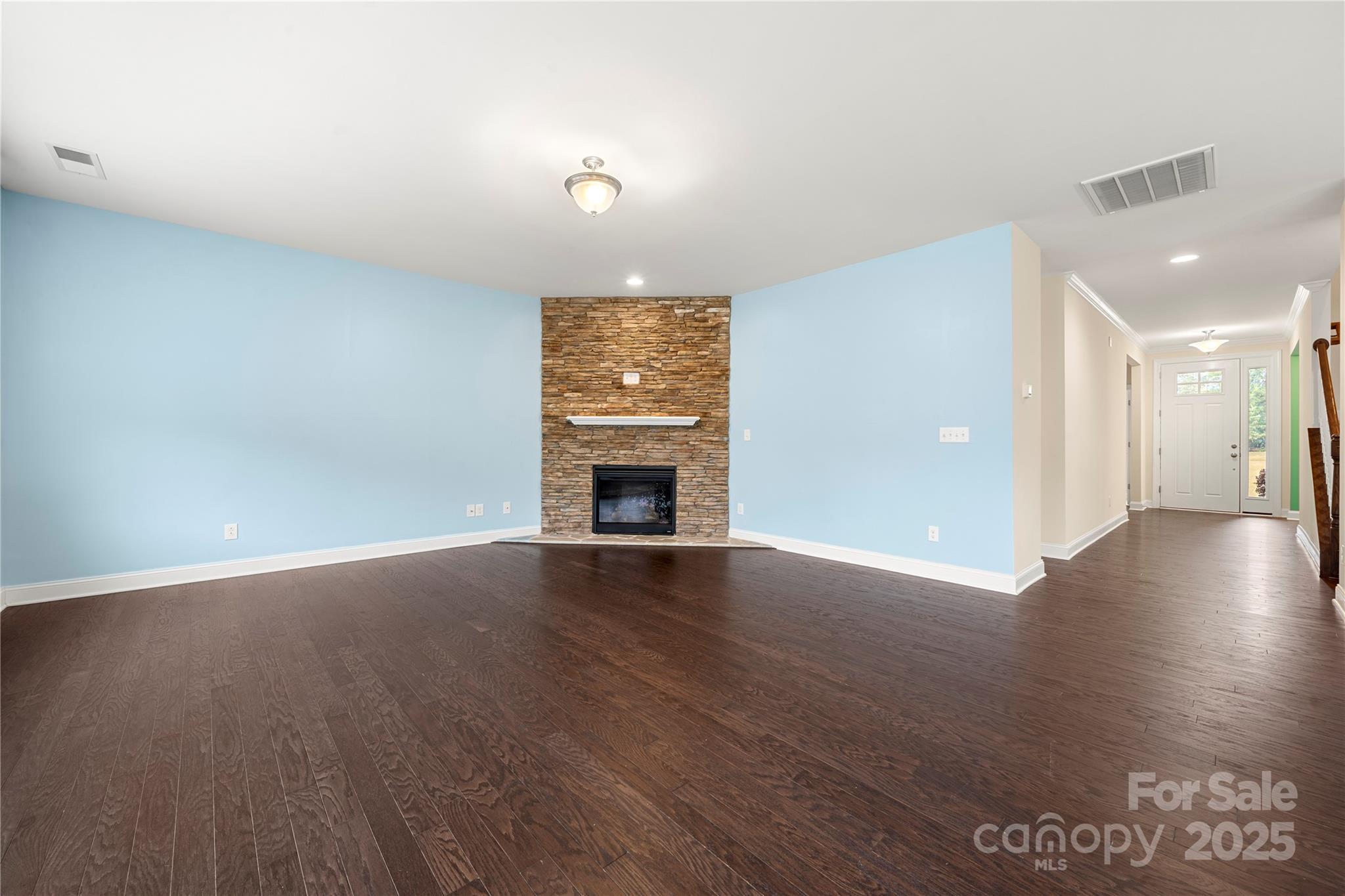 206 Houston Blair Road Matthews, NC 28104 - Photo 13 of 44 an empty room with wooden floor and a fireplace