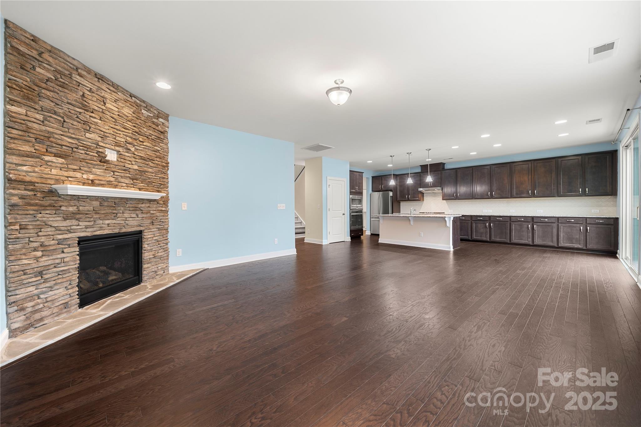 206 Houston Blair Road Matthews, NC 28104 - Photo 14 of 44 a view of a living room with kitchen and fireplace