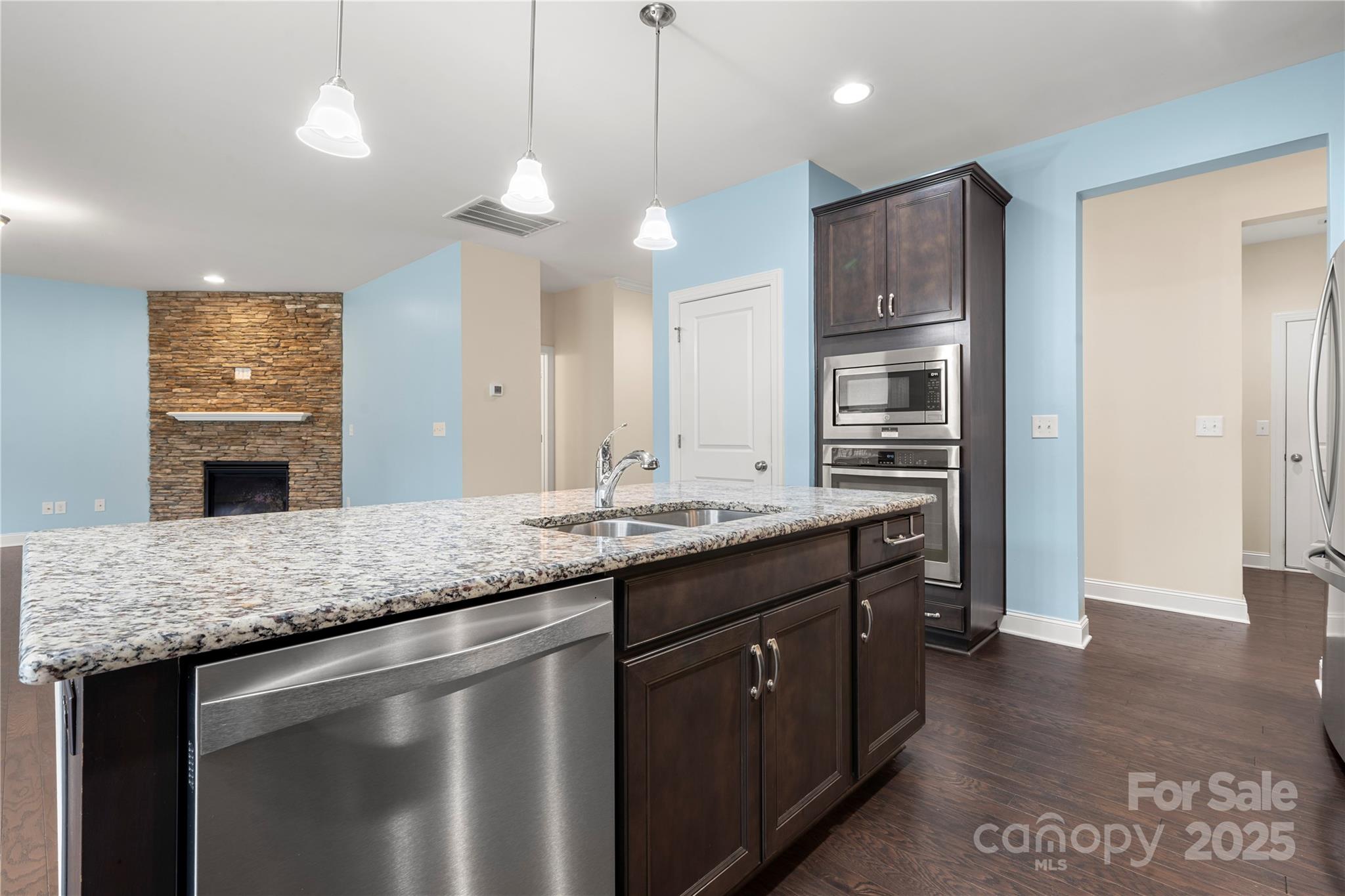 206 Houston Blair Road Matthews, NC 28104 - Photo 16 of 44 a kitchen with kitchen island granite countertop a sink and a refrigerator