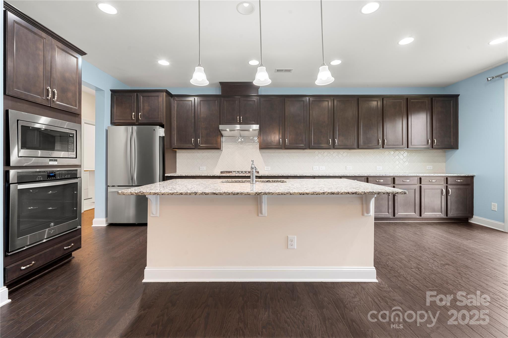 206 Houston Blair Road Matthews, NC 28104 - Photo 17 of 44 a kitchen with kitchen island a counter top stainless steel appliances and cabinets