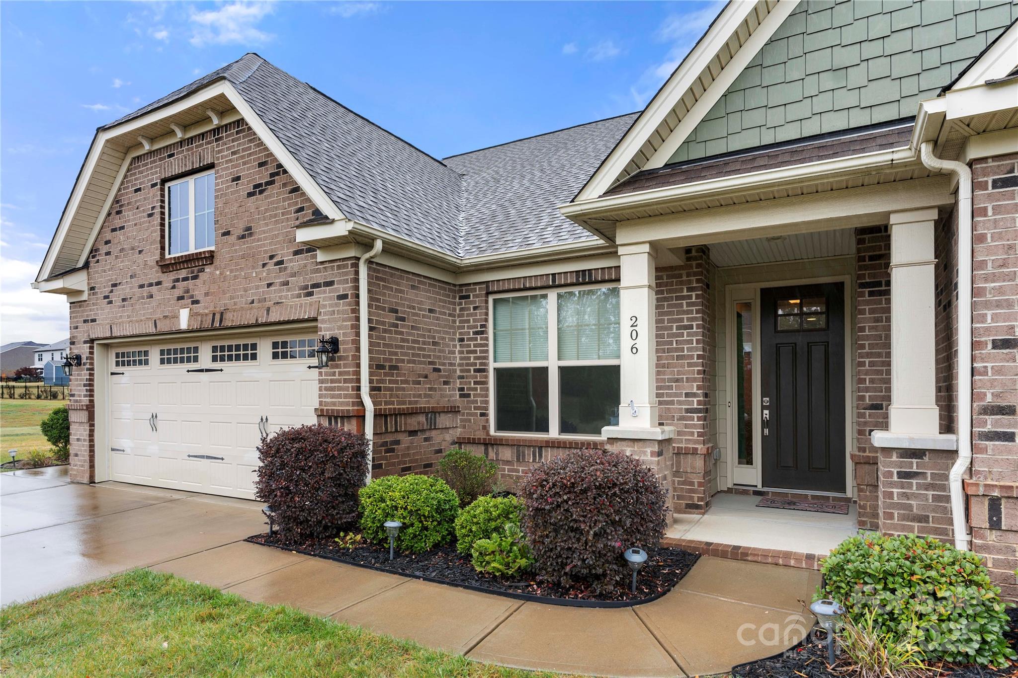 206 Houston Blair Road Matthews, NC 28104 - Photo 2 of 44 a front view of a house with garden