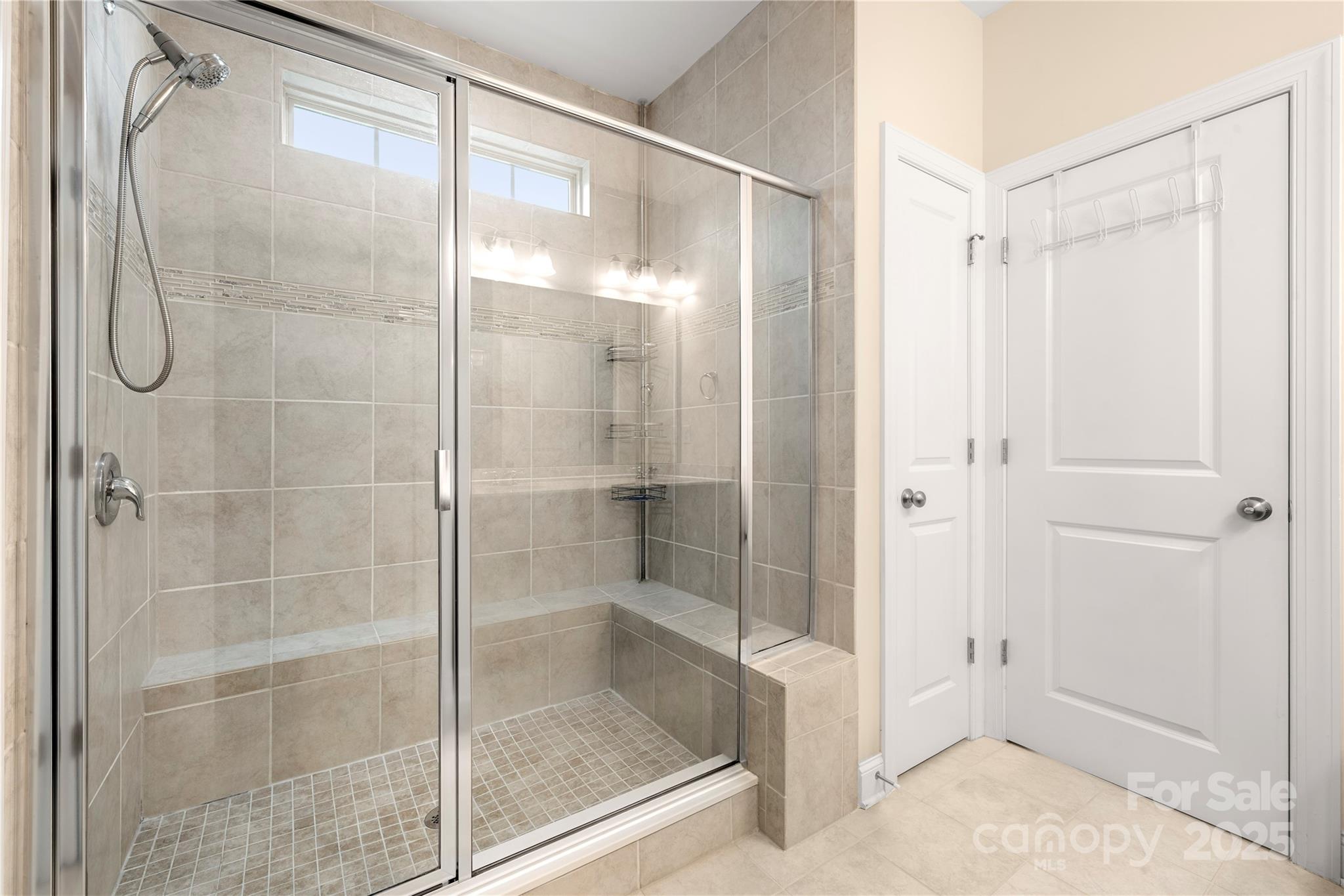 206 Houston Blair Road Matthews, NC 28104 - Photo 26 of 44 a bathroom with a glass shower door