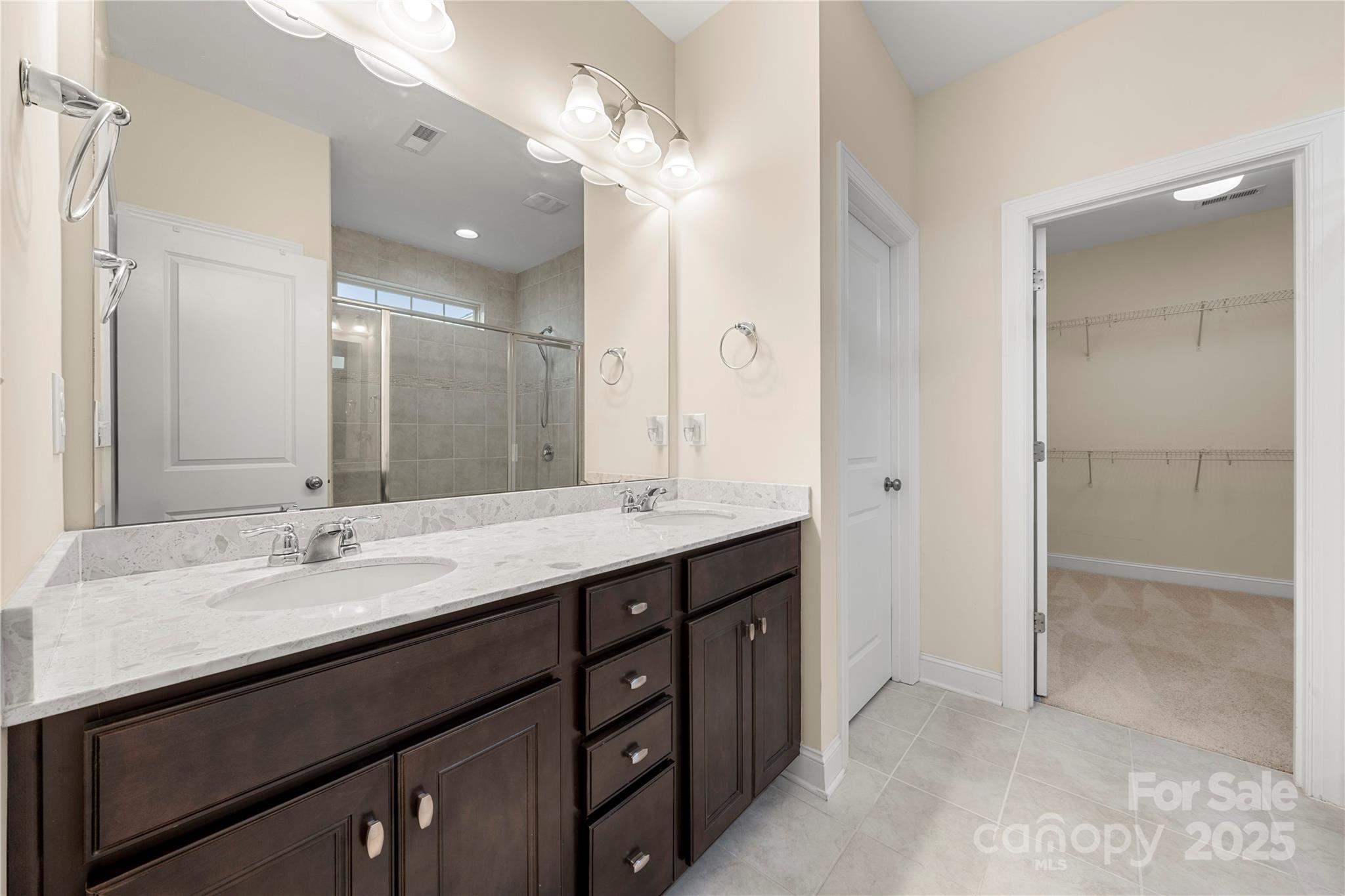 206 Houston Blair Road Matthews, NC 28104 - Photo 27 of 44 a bathroom with a granite countertop sink a large mirror and a shower