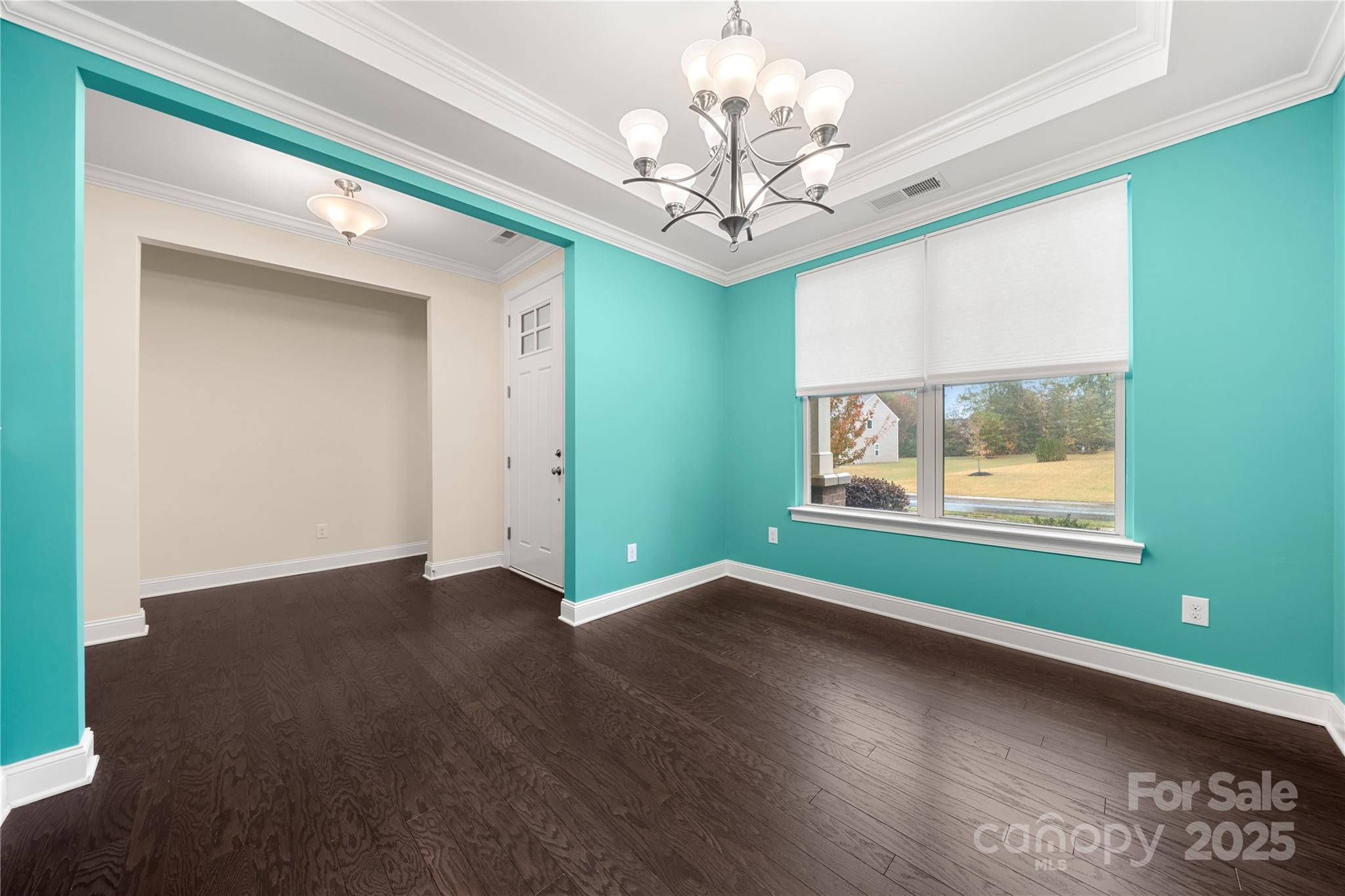 206 Houston Blair Road Matthews, NC 28104 - Photo 9 of 44 a view of an empty room with wooden floor and a window