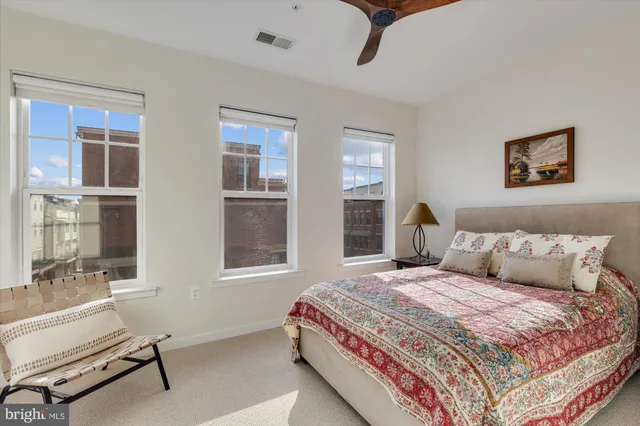 a bedroom with a bed and glass windows
