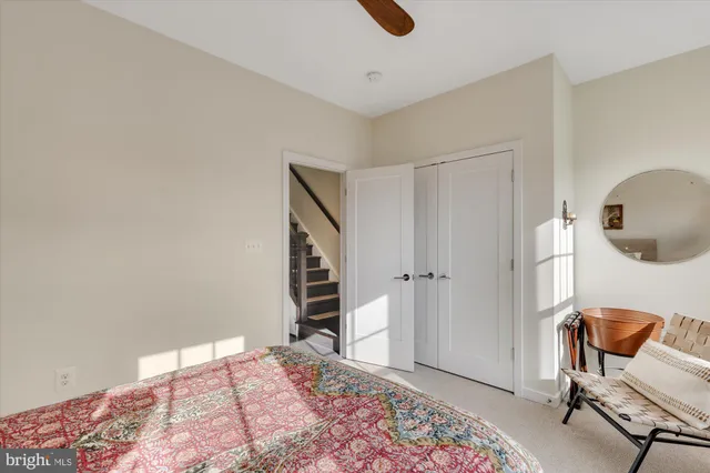 a bedroom with a chair and wooden floor