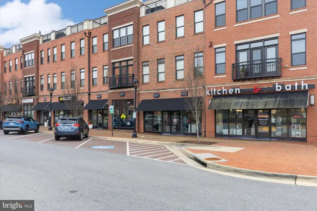 a man walking down a street next to a building