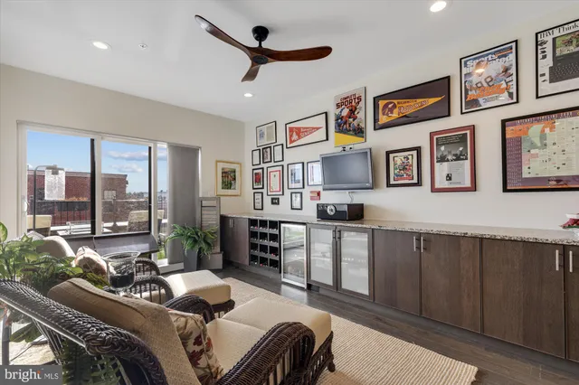 a bedroom with furniture and a large window